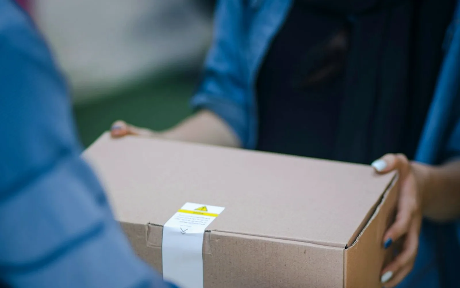 Professional parcel handover used to represent one-off urgent same-day deliveries